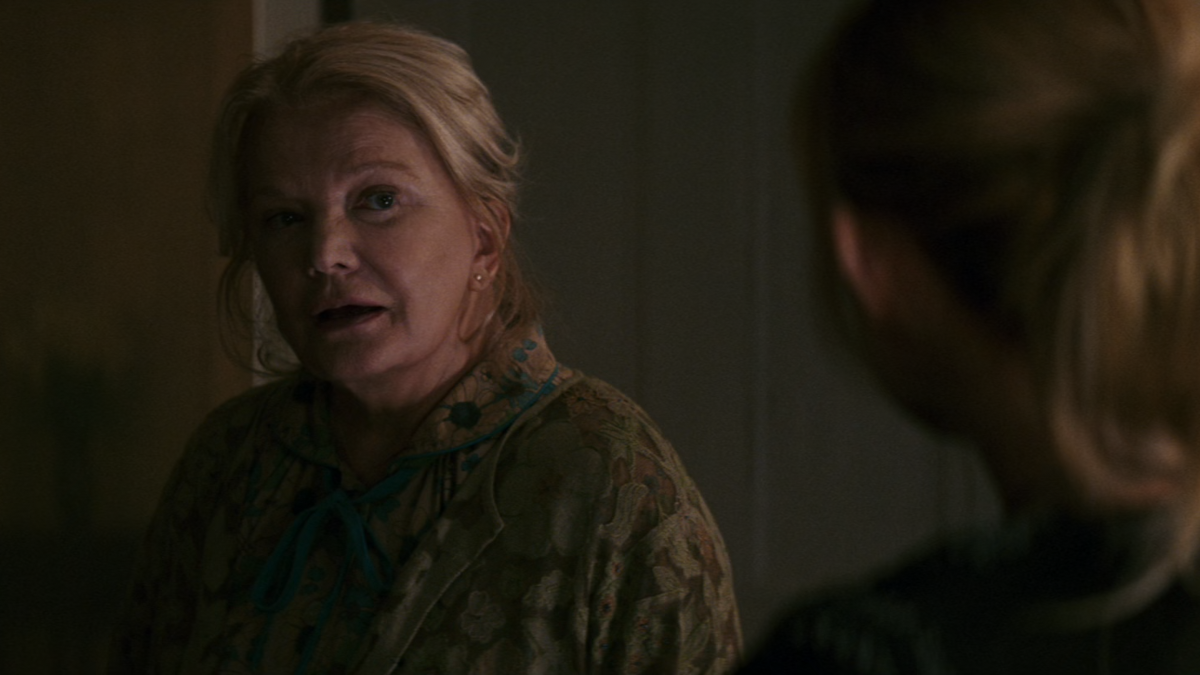 An old woman is looking at another woman.